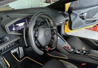 the interior of a black and yellow sports car